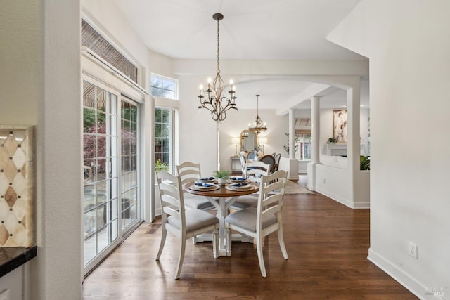 dining room with wood-type flooring and a notable chandelier