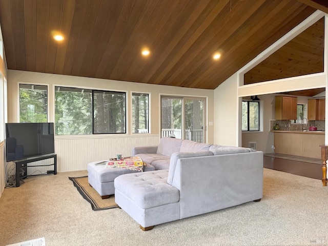 carpeted living area with wood ceiling, visible vents, vaulted ceiling, and a sink