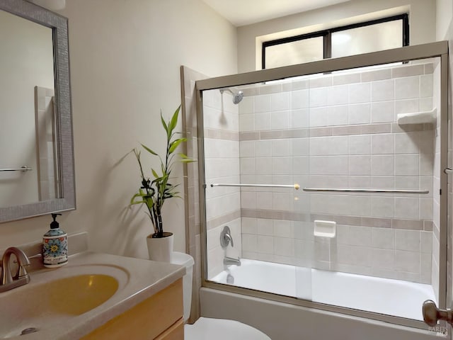 full bathroom with toilet, combined bath / shower with glass door, and vanity