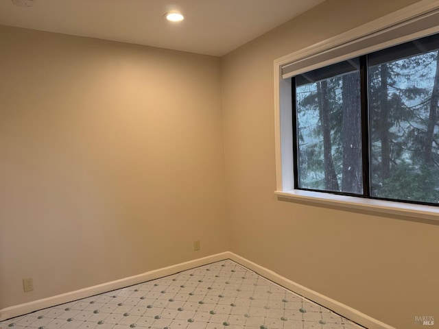 unfurnished room with light floors, baseboards, and recessed lighting