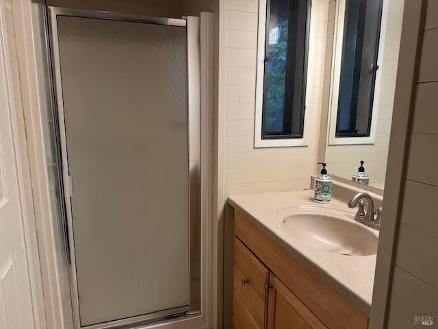 full bathroom featuring a stall shower and vanity