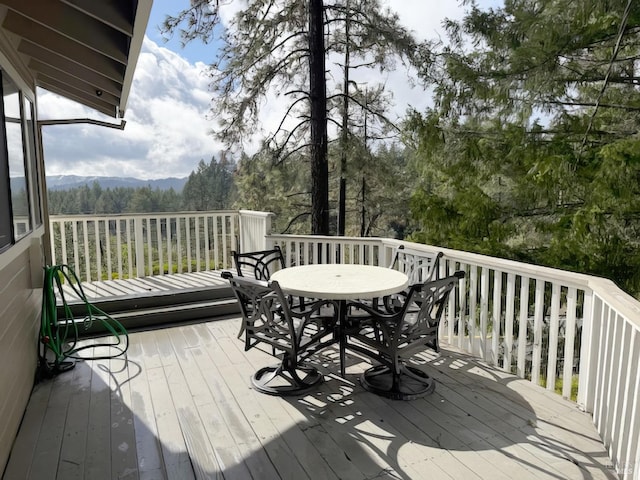 wooden deck featuring outdoor dining space