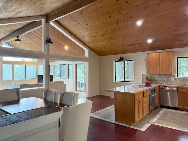 kitchen with lofted ceiling with beams, appliances with stainless steel finishes, open floor plan, a peninsula, and backsplash