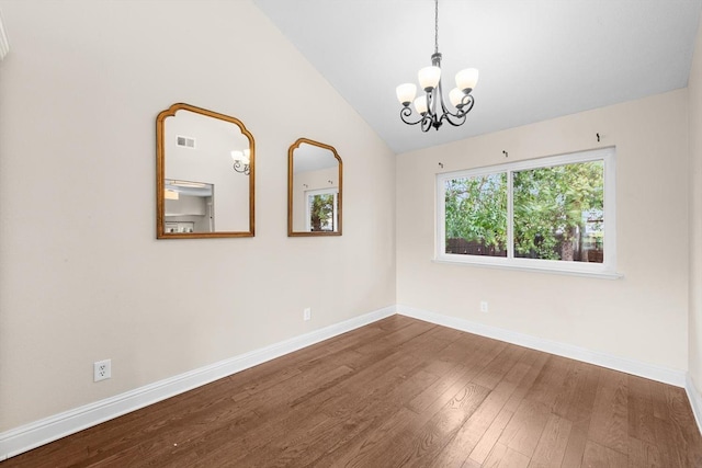 unfurnished room with baseboards, vaulted ceiling, hardwood / wood-style floors, and a chandelier