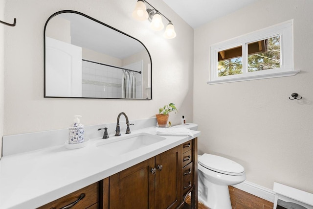 full bathroom featuring curtained shower, vanity, toilet, and wood finished floors