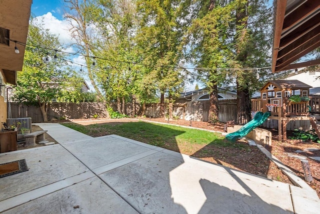 view of yard with a playground, a patio area, and a fenced backyard