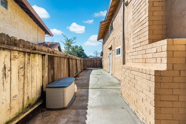 view of side of home featuring a patio area and fence