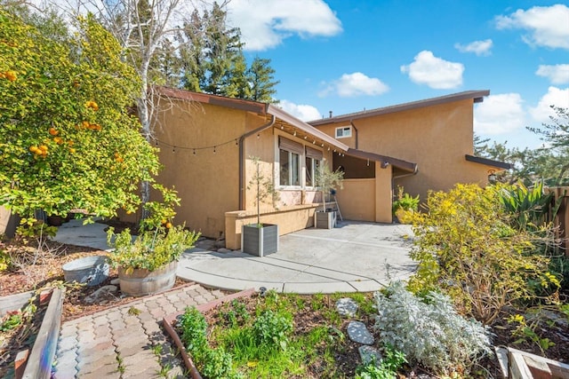 back of property featuring stucco siding and a patio