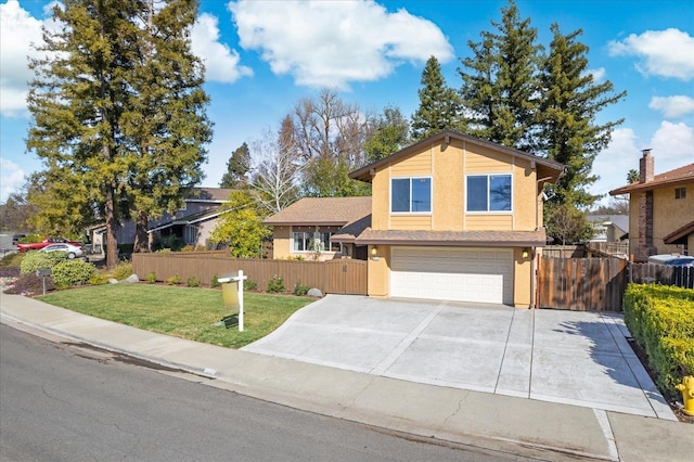 view of front of home featuring a garage, fence, concrete driveway, and a front yard