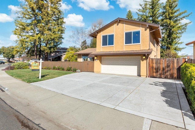 view of front facade with concrete driveway, an attached garage, fence, and stucco siding