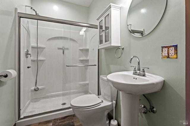 bathroom featuring walk in shower, wood-type flooring, and toilet