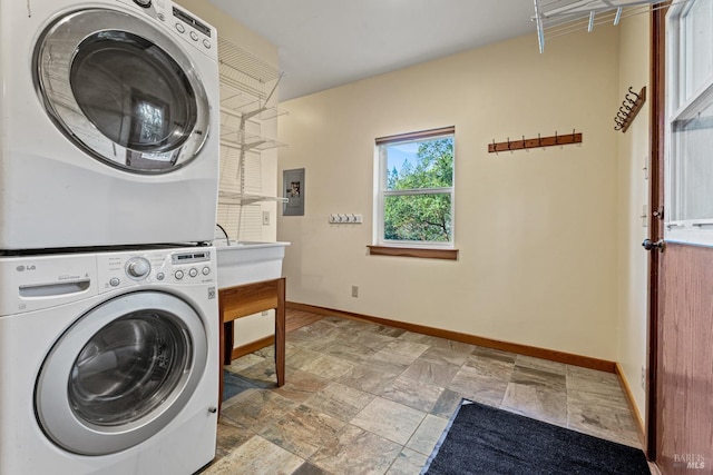 washroom featuring stacked washer and clothes dryer