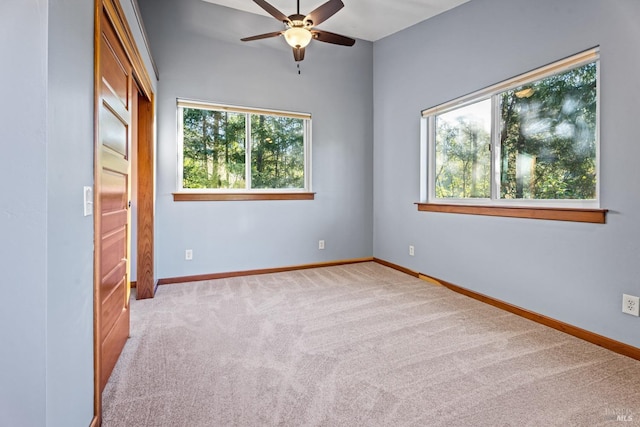 unfurnished bedroom featuring light carpet and ceiling fan