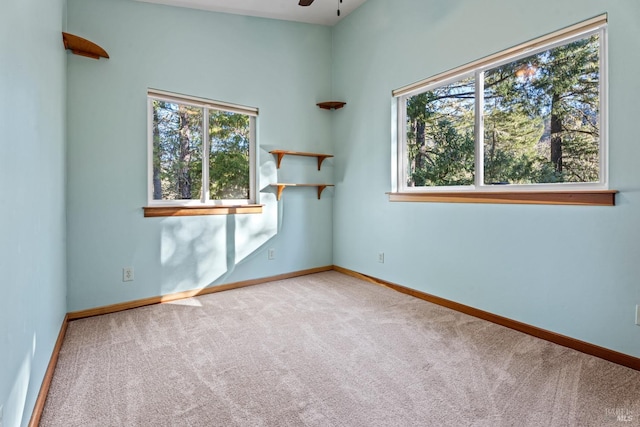 empty room with ceiling fan and carpet flooring