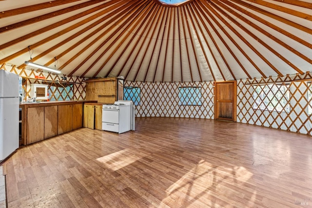 bonus room with lofted ceiling with beams and light hardwood / wood-style floors