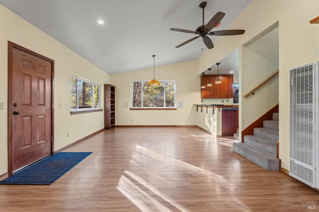 unfurnished living room with high vaulted ceiling, hardwood / wood-style floors, and ceiling fan