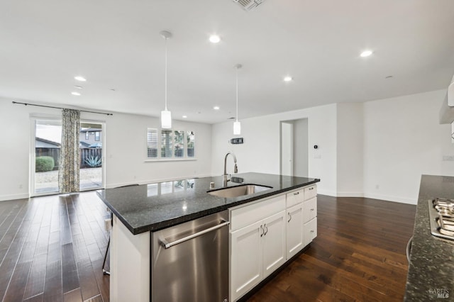 kitchen featuring sink, dishwasher, white cabinetry, dark stone countertops, and decorative light fixtures