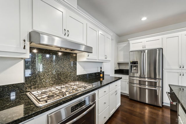 kitchen with white cabinetry, stainless steel appliances, dark hardwood / wood-style flooring, and tasteful backsplash