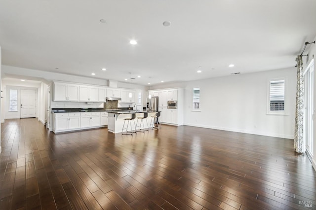 living room with a healthy amount of sunlight and dark hardwood / wood-style floors