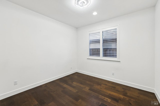 unfurnished room featuring dark wood-type flooring