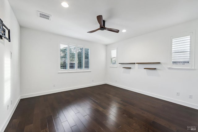 unfurnished room with dark wood-type flooring and ceiling fan