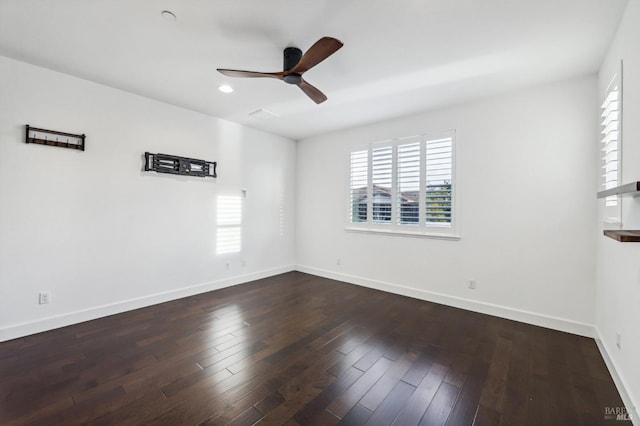 spare room featuring dark wood-type flooring and ceiling fan