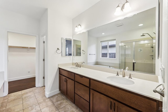 bathroom with tile patterned flooring, vanity, and an enclosed shower