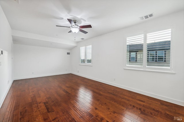 empty room with dark wood-type flooring and ceiling fan