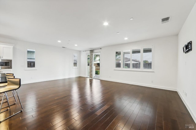 unfurnished living room featuring dark wood-type flooring