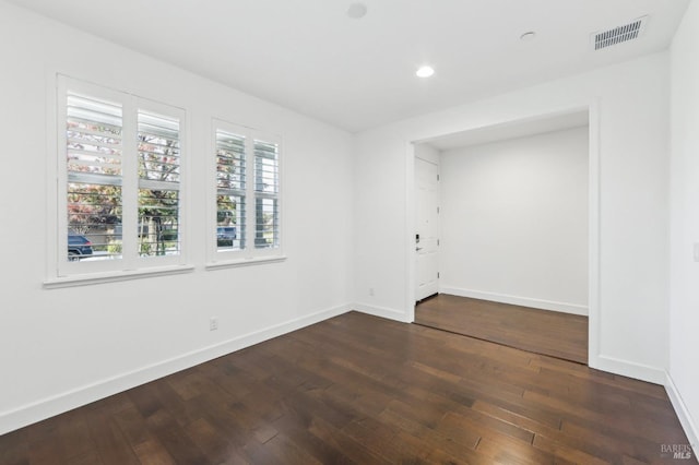 spare room featuring dark hardwood / wood-style flooring