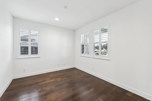 unfurnished room with dark hardwood / wood-style flooring