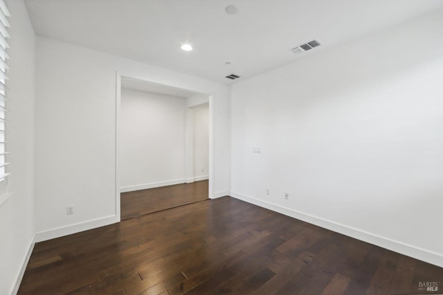 unfurnished room with dark hardwood / wood-style floors