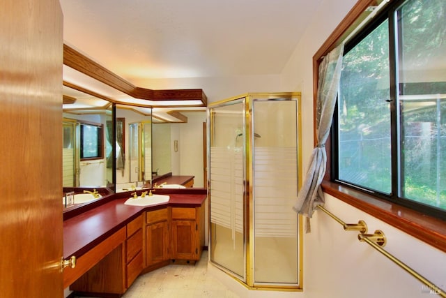 full bathroom with a shower stall, vanity, and tile patterned floors