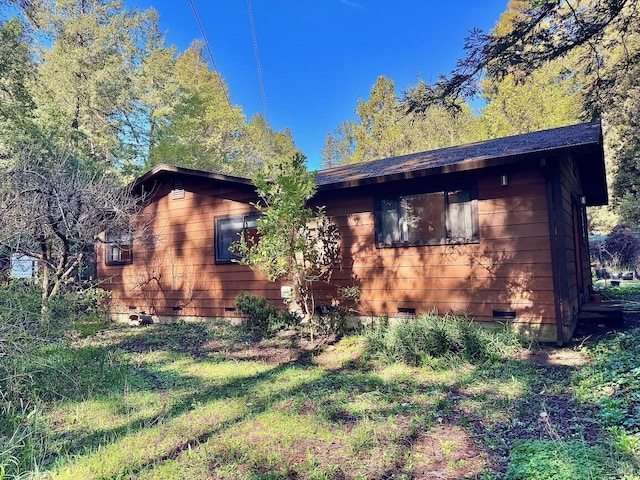 view of side of home featuring crawl space