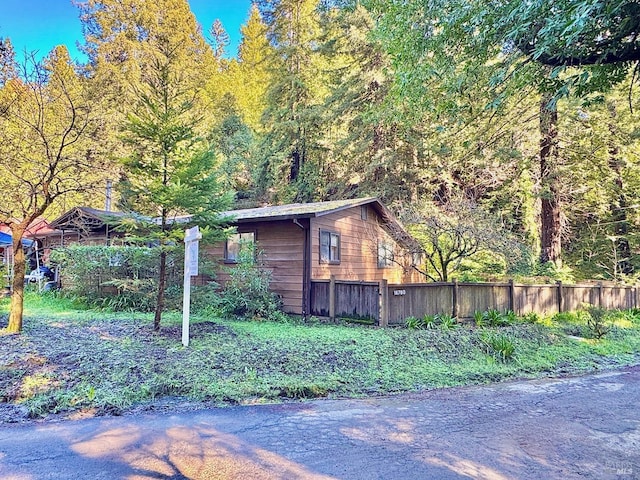 view of side of property featuring fence