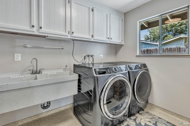 laundry room with cabinet space and washing machine and clothes dryer