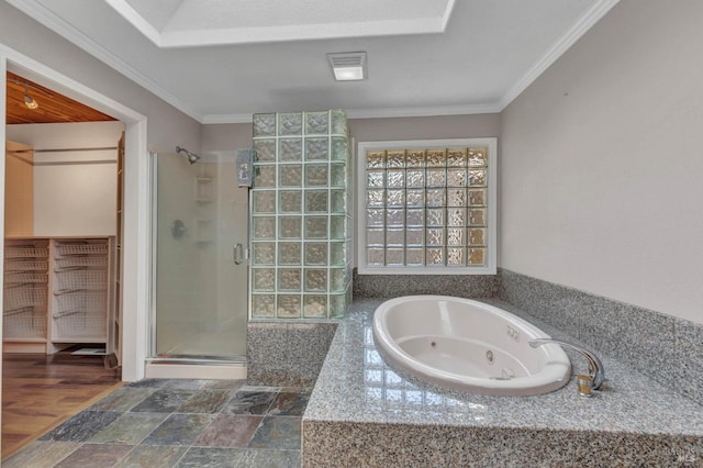 bathroom with a jetted tub, visible vents, crown molding, and a shower stall