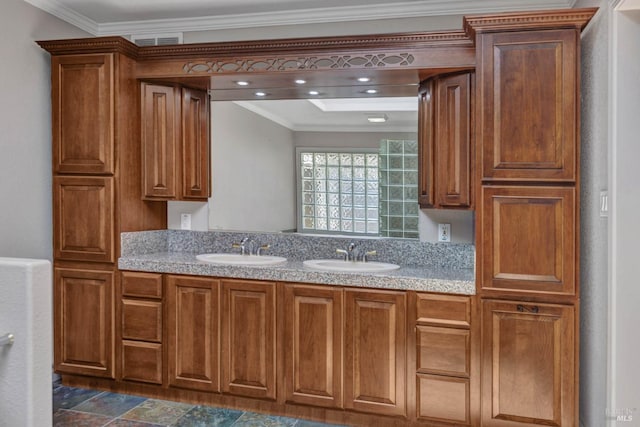 kitchen featuring ornamental molding, a sink, and visible vents