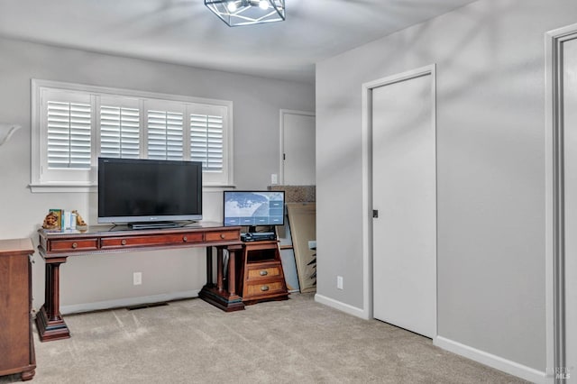 carpeted home office with baseboards