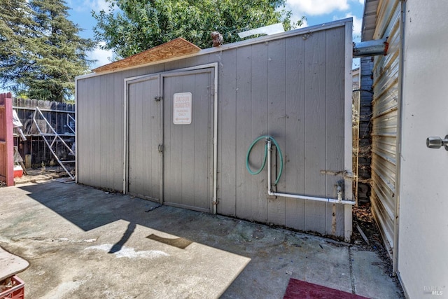 view of shed featuring fence