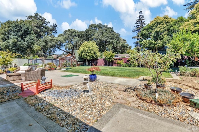 view of yard with a patio area, fence, and outdoor lounge area