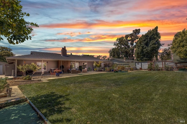 view of yard with fence and a patio