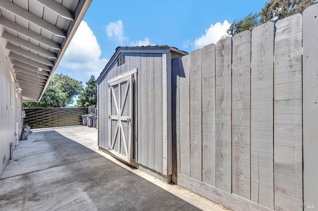 view of shed with fence