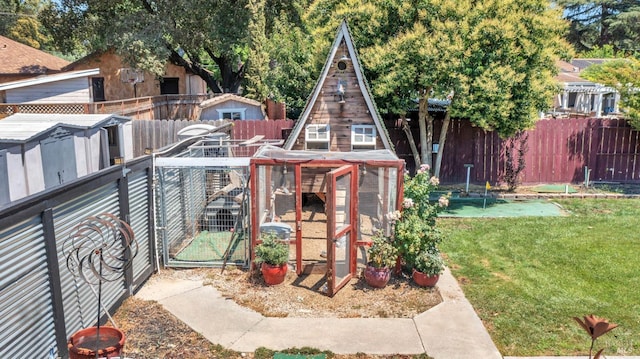 exterior space with a fenced backyard, exterior structure, and an outbuilding