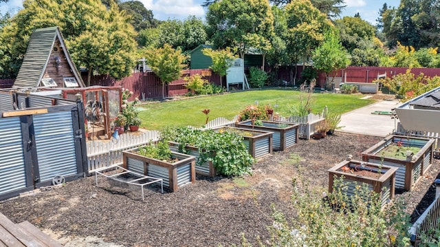 view of yard with a vegetable garden and fence