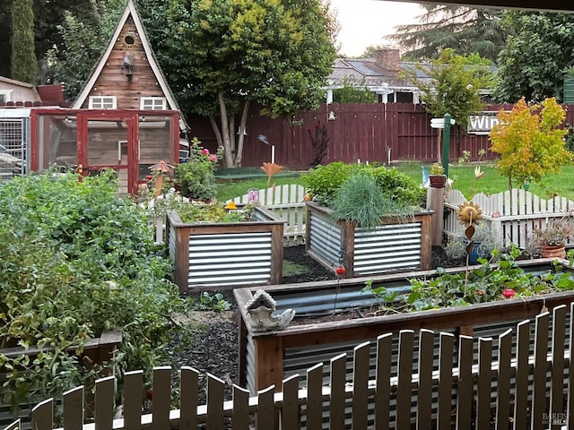 exterior space with a vegetable garden and fence