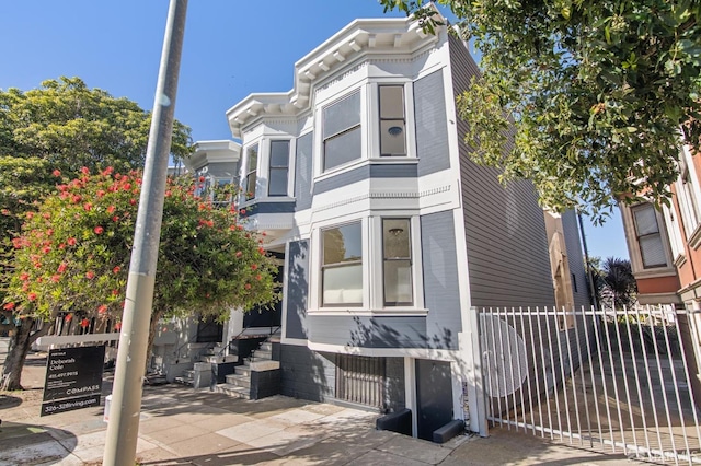 view of front of house featuring entry steps and fence