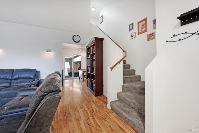 living room featuring hardwood / wood-style flooring and a high ceiling