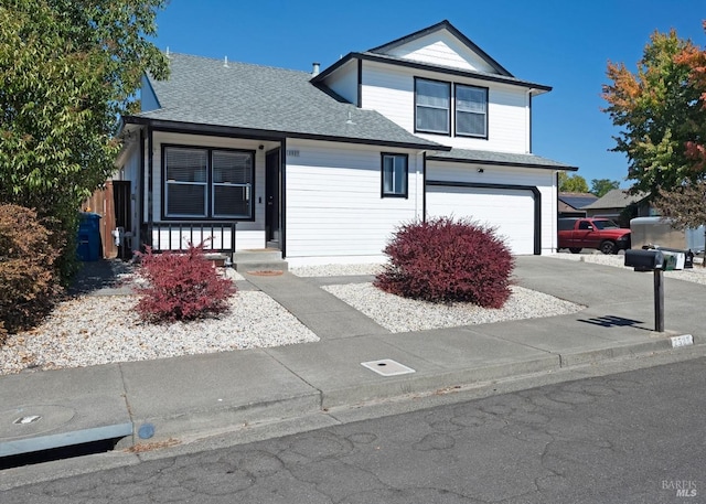 view of property with a garage and a porch