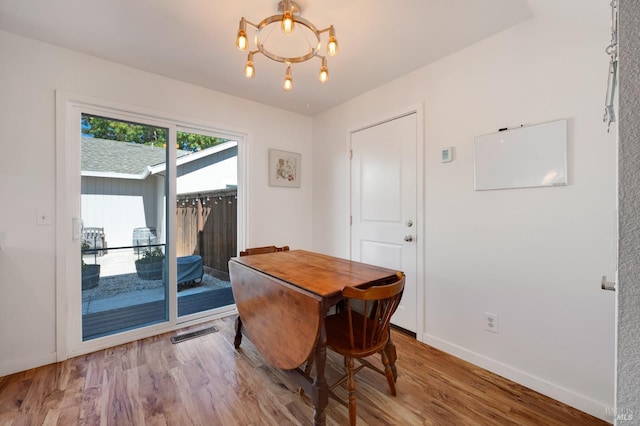 dining room featuring an inviting chandelier and light wood-type flooring